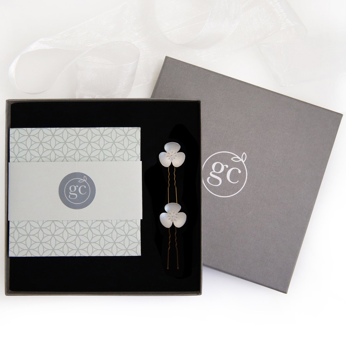 Two Silver Poppy hairpins, which instantly convert to a pair of earrings