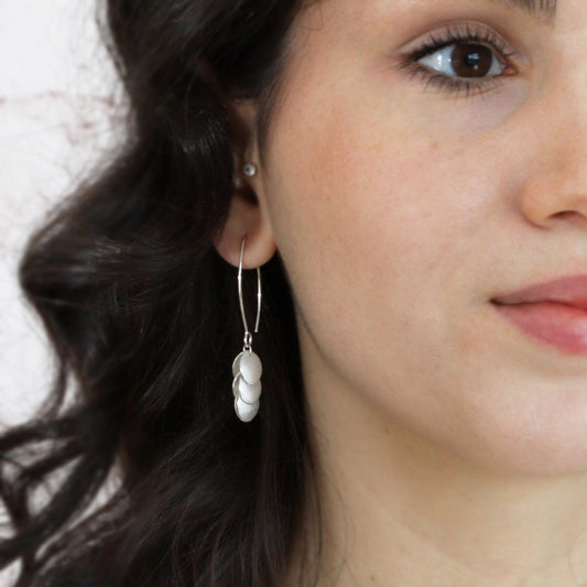 silver petal long earrings being worn by model, close p