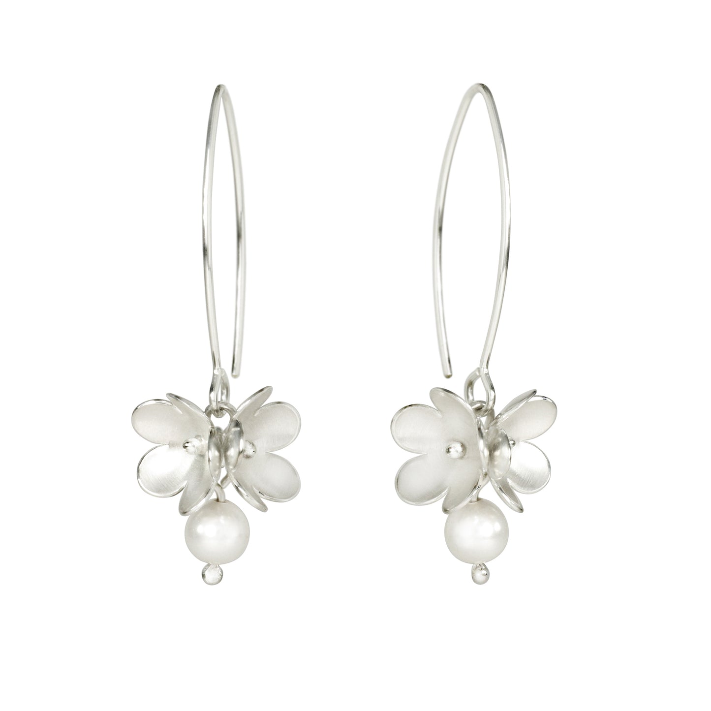 A pair of silver drop earrings featuring a small blossom flower charm with a dangling pearl bead, suspended from thin silver hooks against a plain white background.