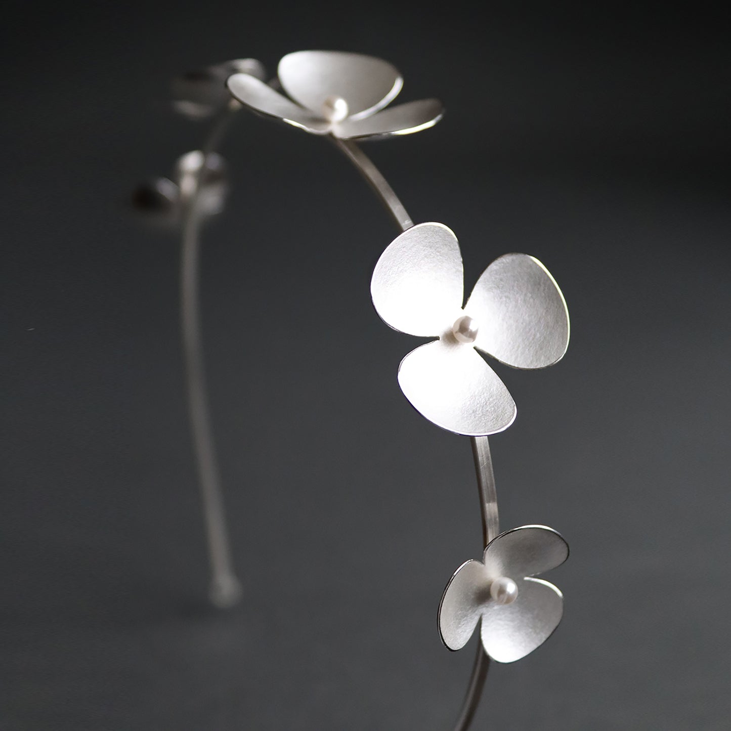 Silver Poppy headband, which becomes a set of jewellery