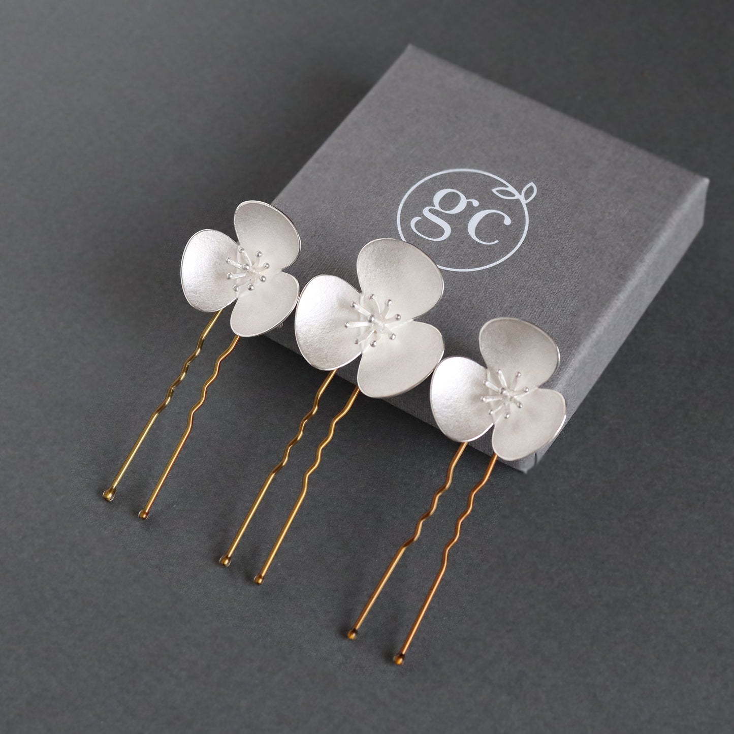 Three Silver Poppy hairpins, which instantly convert to a set of jewellery