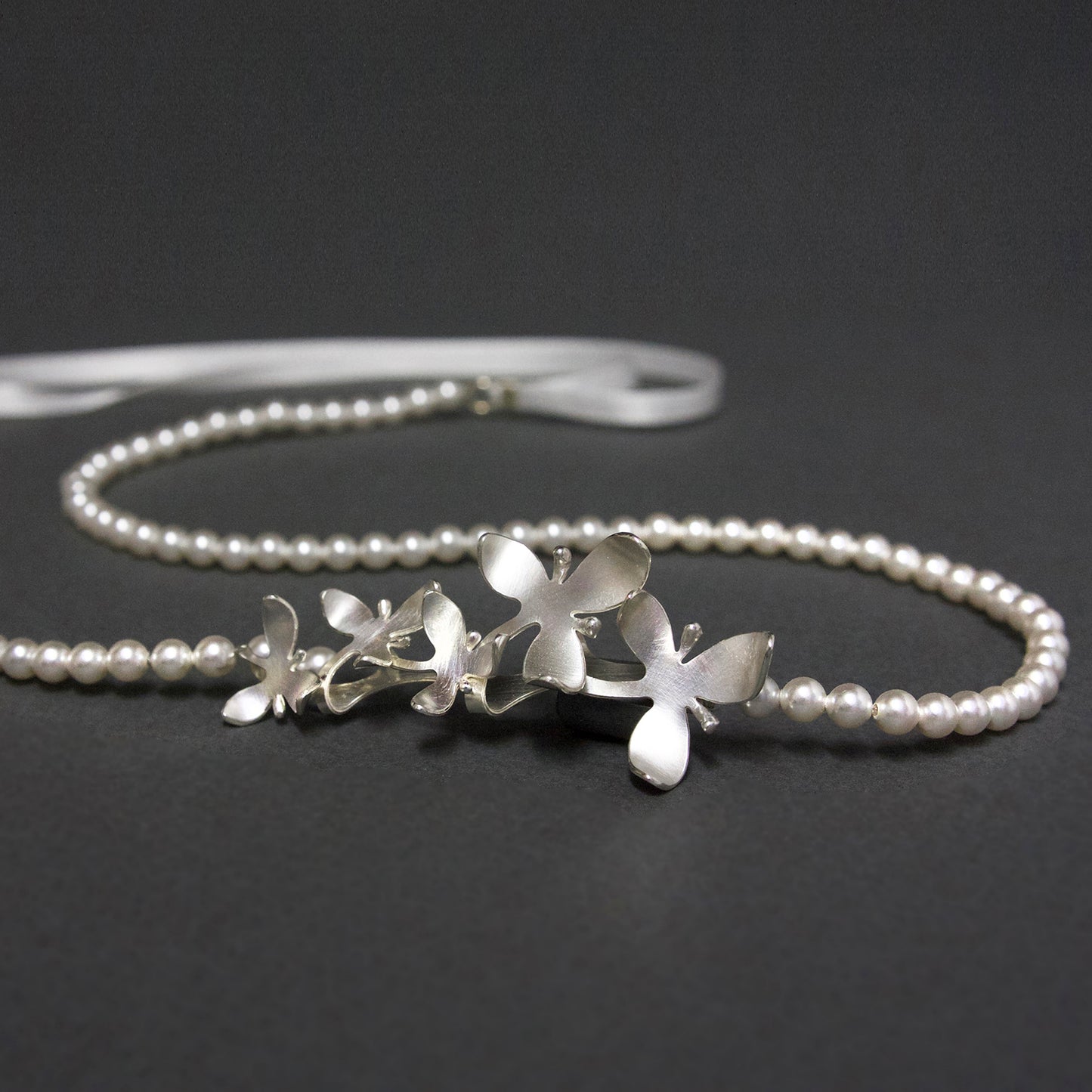 Silver Orchid flowers on pearl soft headband, becomes a pendant